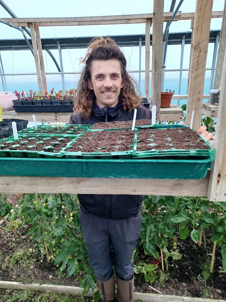 James from Papay admiring some newly planted seeds.